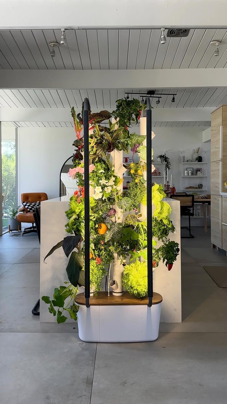 25 Creative and Gardening Ideas for Backyards Big or Small 10 A vertical indoor garden tower with lush green plants growing in a modern room.