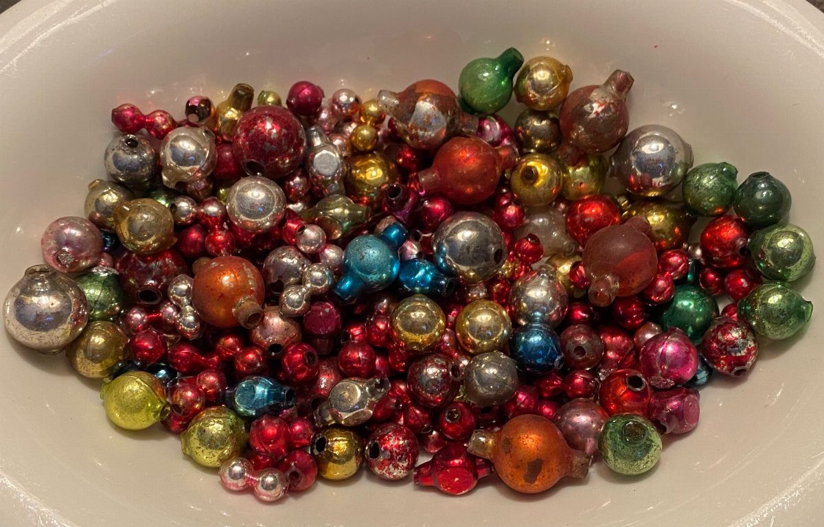 11 DIY Christmas Holiday Decorations: From Wine Corks to Walnut Reindeer 8 Small colorful mercury glass ornaments in a white bowl.