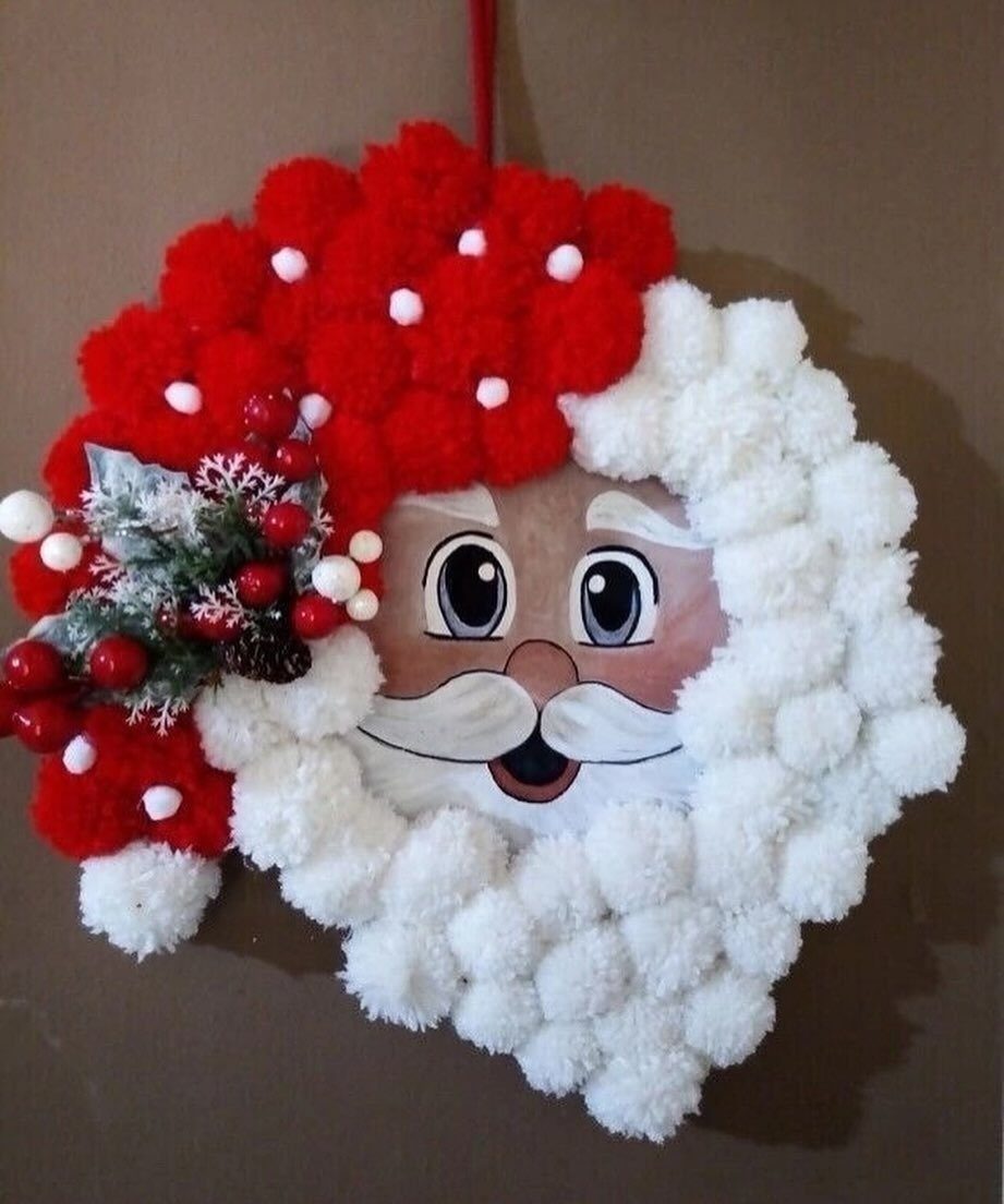 11 DIY Christmas Holiday Decorations: From Wine Corks to Walnut Reindeer 6 Santa Claus face wreath made of red and white pom poms with pine decorations.