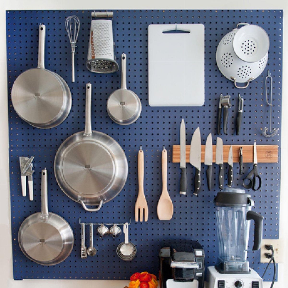 5 DIY Kitchen Ideas for Storage That Actually Fits Your Space 5 Stainless steel pans and kitchen utensils hanging organized on a blue pegboard wall organizer.