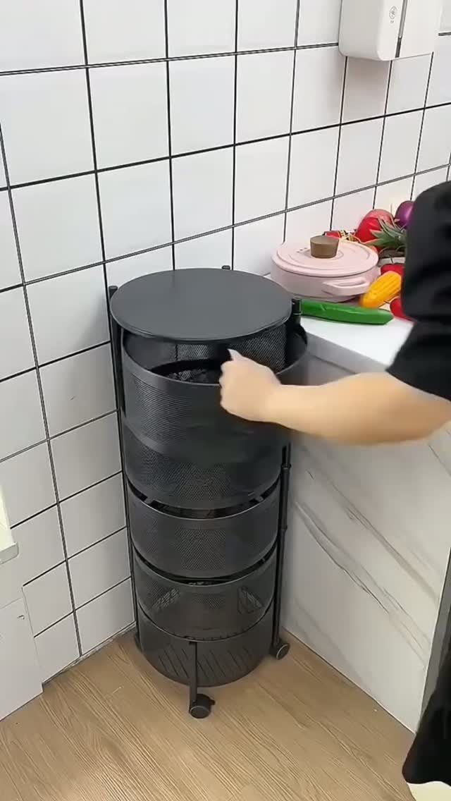 5 DIY Kitchen Ideas for Storage That Actually Fits Your Space 1 A person's hand reaching for a black four-tier metal rolling storage cart in a kitchen.