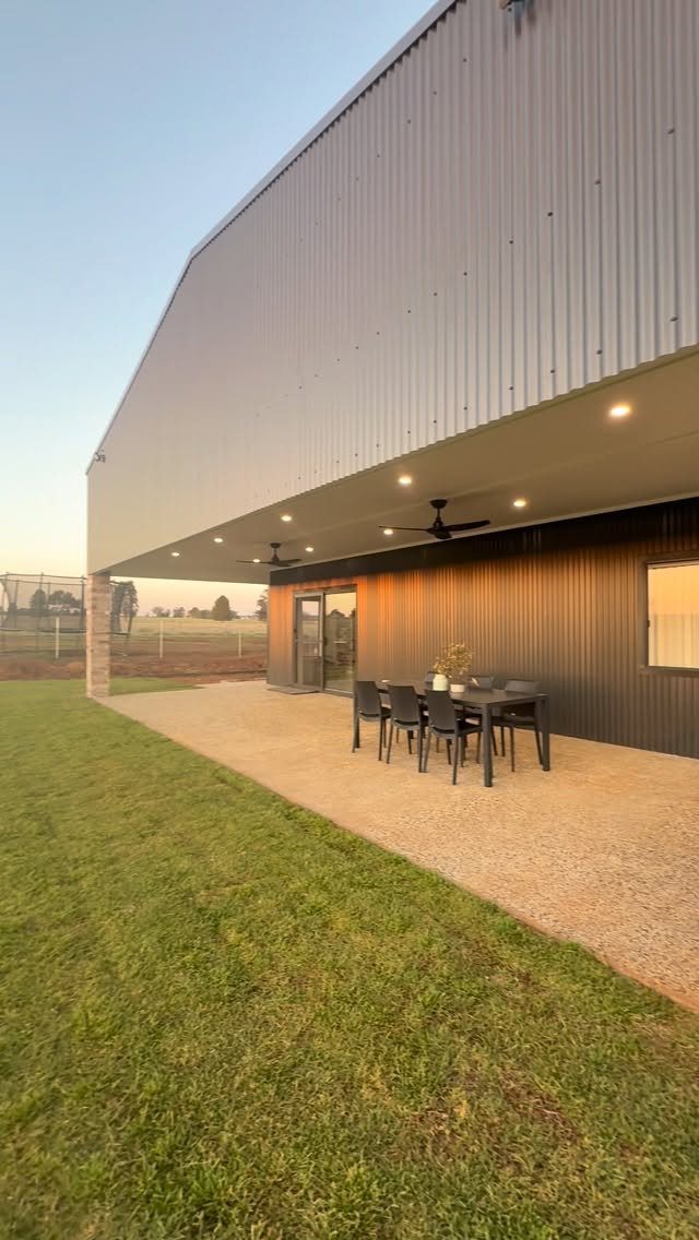 10 Ideas for Farmhouse Shed Home Style 10 Modern corrugated metal farmhouse shed home with a large covered outdoor dining patio area.