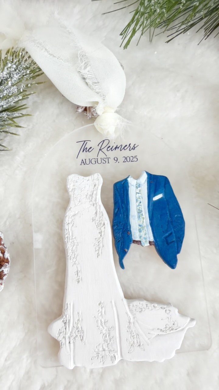 Acrylic wedding ornament featuring a white dress and blue suit with a custom name and date.