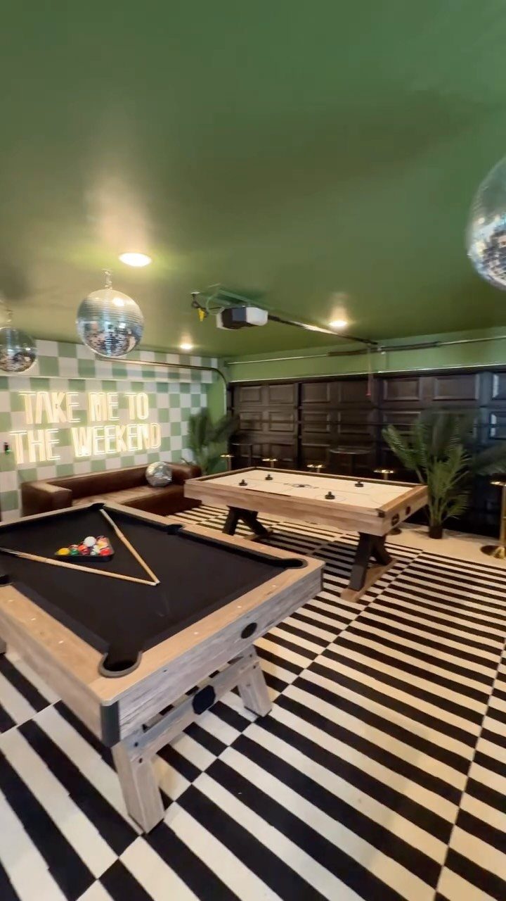 6 Small Garage Building Ideas for Storage, Projects & Living Space 4 Two pool tables sit on a checkered floor in a green-ceilinged game room.